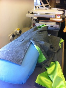 Setting the vents on a coat ready to press.