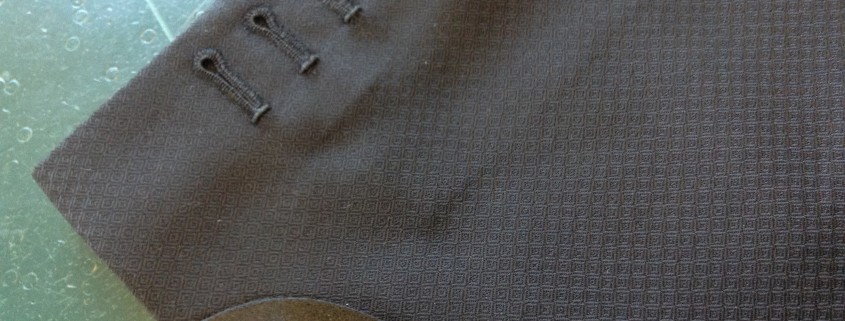 hand-made button holes. Four real hand made button holes, and a pure silk gauntlet cuff. 